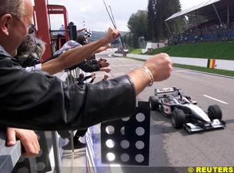 Mika Hakkinen takes the chequered flag