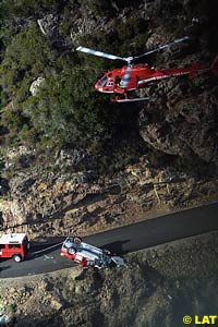 The helicopter which took Mannisenmaki to hospital hovers over the car on the edge of the valley