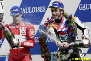 Valentino Rossi on the podium with second placed Alex Barros