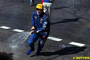 A happy winner Marcos Ambrose sprays the champers