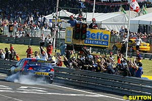 Winner Marcos Ambrose locks his brakes in celebration after winning race two