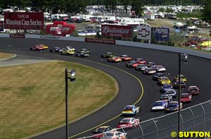 The field races around the New Hampshire oval track just after the start