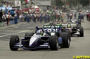 Winner Dario Franchitti leads the field back on to the track after the late race red flag