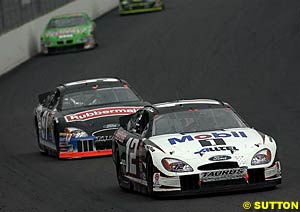 Ryan Newman being chased hard by Kurt Busch