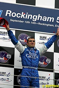 Winner Dario Franchitti celebrates on the podium