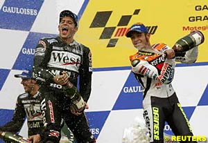 Valentino Rossi sprays race winner Alex Barros with champagne as Barros's teammate Loris Capirossi sprays his champagne elsewhere