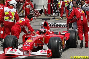 Barrichello is pushed back into the garage