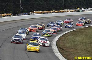 Casey Mears and Joe Nemechek lead the field behind the pace car before the start