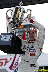 Richard Lyons holds the trophy for winning the Formula Nippon championship